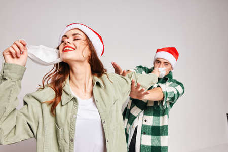 man and woman wearing medical masks Christmas New Year Studio celebration