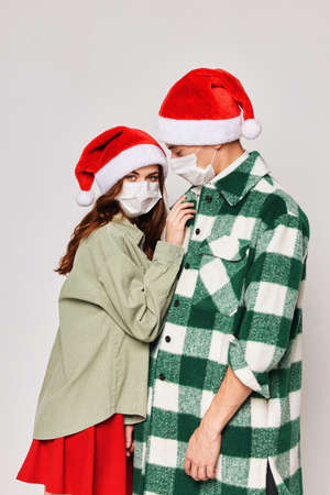 Man and woman New Years medical masks protection hugs careの写真素材