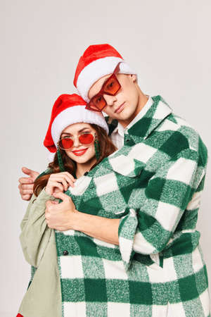 A man hugs a woman young couple New Years sunglasses holiday friendshipの写真素材