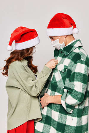 Woman buttons shirt man Christmas hats caring winter Christmasの写真素材