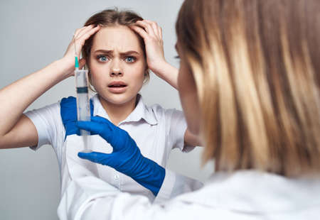 female doctor in blue gloves injection syringe communication patient