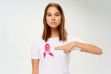 woman in a white t-shirt Ribbon charity foundation care and treatment Copy Spaceの写真素材