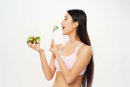 woman with a plate of salad eating slim figure vegetarian