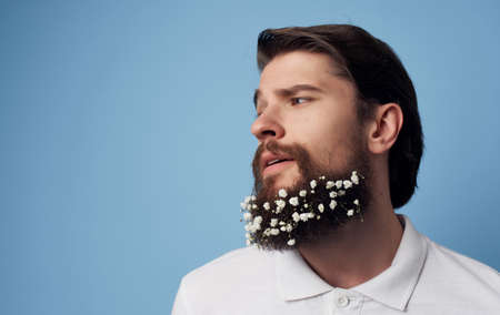 Cute man with flowers in a beard emotions Studio lifestyleの写真素材
