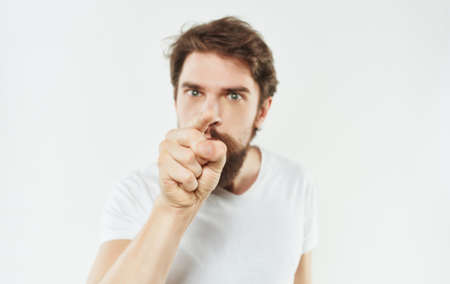 Man in white t-shirt hand gesture cropped view Studioの写真素材