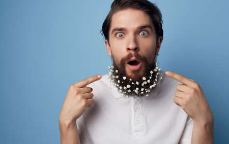 Cute man with flowers in a beard emotions Studio lifestyleの写真素材