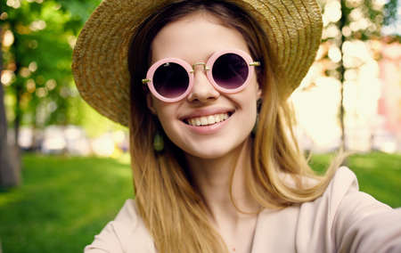 Pretty woman in hat and sunglasses outdoors walk park fresh air nature