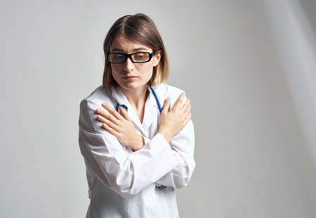 portrait of female nurse in medical gown and blue stethoscopeの写真素材