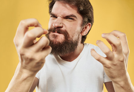 Angry man in white T-shirt mental deviation thick beard modelの写真素材