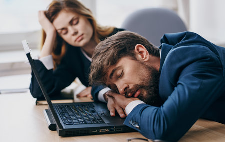 Work colleagues asleep at the desk in front of the laptop fatigue restの写真素材