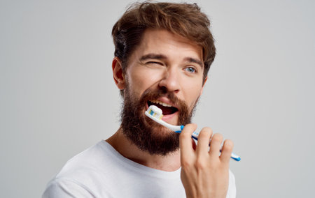 man with a toothbrush in his hands oral cavity care toothpaste modelの写真素材