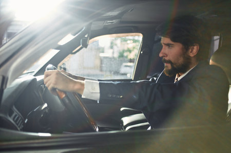 rich man in suit driving car trip road success lifestyleの写真素材