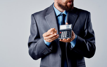 Cryptocurrency Bitcoin rich man calculator finance business model Copy Spaceの写真素材