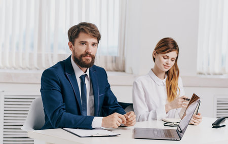 man and woman with laptop in office communication employees business finance