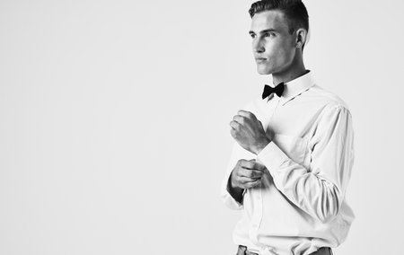 Side view of a handsome gentleman in a shirt in a bow tie