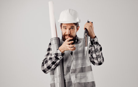 man in working uniform white helmet drawings profession engineerの写真素材