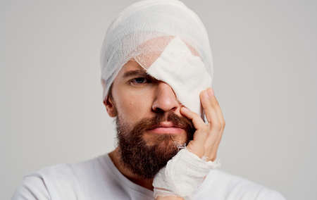 man with a bandaged head health problems trauma emergency room hospitalizationの写真素材