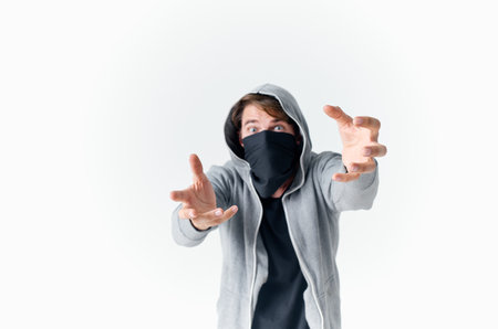 masked man with a hood gesturing with his hands theft gangster crime