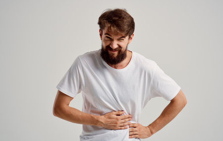 man touching stomach with hand pain stomach problemsの写真素材