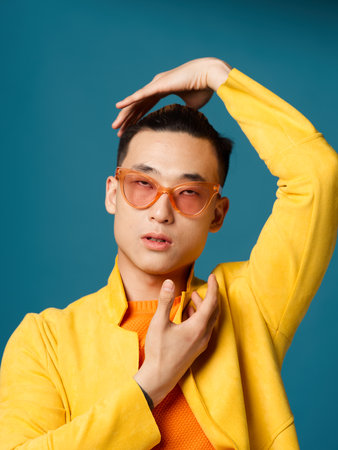 Man gesturing with his hands near his face on a blue background cropped viewの写真素材
