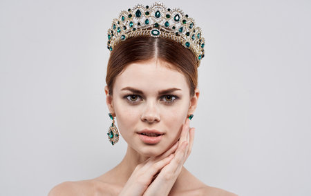 Beautiful woman princess diadem jewelry nude shoulders close-upの写真素材