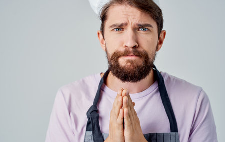 chef in apron and beard headdress success pink t-shirtの写真素材