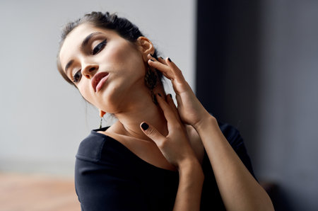 romantic woman model portrait earrings makeup and evening dress light backgroundの写真素材