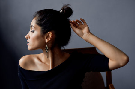 romantic woman model portrait earrings makeup and evening dress gray backgroundの写真素材