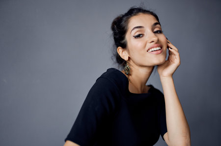 elegant lady in black dress makeup model earrings interiorの写真素材