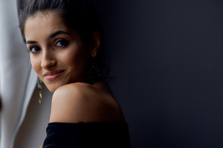 elegant lady indoors near window interior model gray curtainsの写真素材