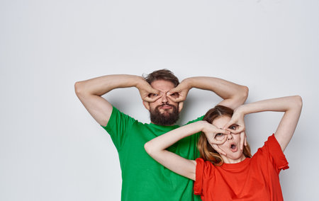 emotional man and woman in colorful t-shirts family lifestyle studioの写真素材