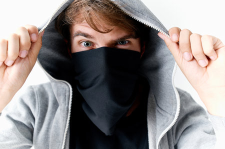 man with a hood on his head theft crime Studio light backgroundの写真素材