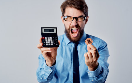 Bearded business man financier calculator currency finance market technologyの写真素材