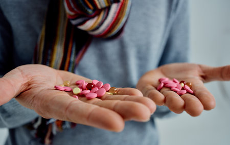 man holding pills in hands health problems cold treatmentの写真素材