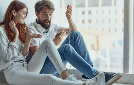 young couple at home near the window technology communication