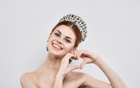 Beautiful woman with diadem on her head Princess queen model with earrings portraitの写真素材