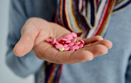 man holding pills in hands health problems cold treatmentの写真素材