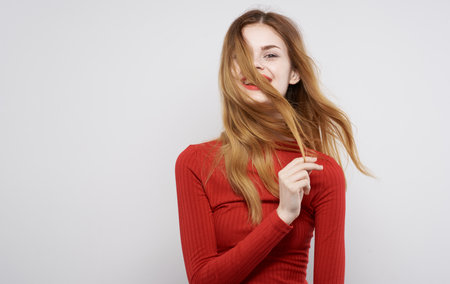 Pretty woman in red dress emotions hairstyle attractive lookの写真素材