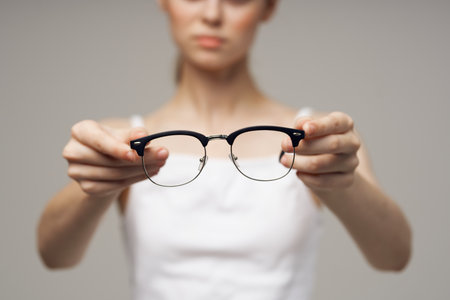woman in white t-shirt glasses vision problems myopia