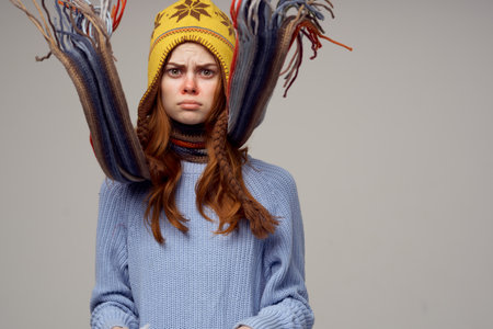 woman with a scarf around her neck headdress sweater warm clothes model