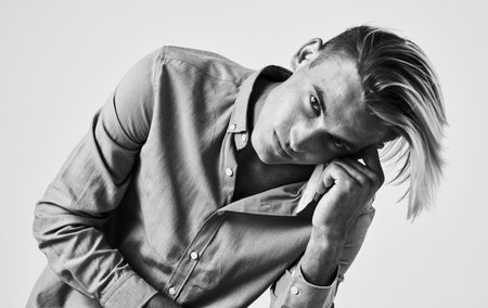 beautiful gentleman in a shirt on a light background gray photograph model