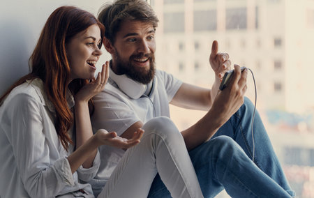 young couple at home near the window technology communicationの写真素材