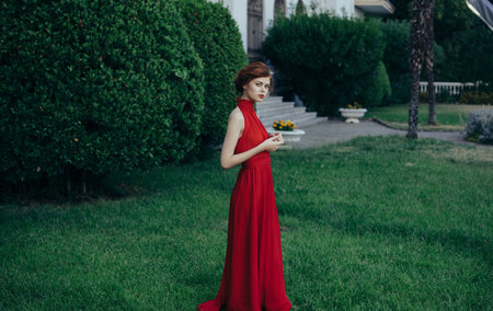 Woman in red dress with electrical insoles Medieval masquerade decorationの写真素材
