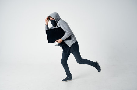 a man in a gray hoodie disguise theft technique hackerの写真素材