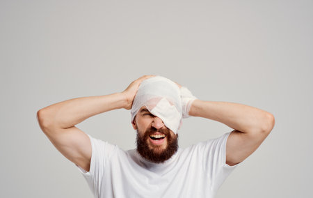 man with bandaged head health problems pain hospitalization trauma centerの写真素材