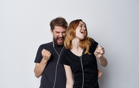 cheerful young couple in headphones listening to music lifestyle emotions friendshipの写真素材