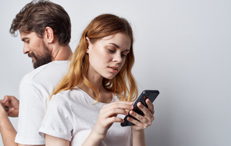 young couple white t-shirt with phone social circle lifestyle friendshipの写真素材