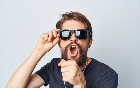 a man with sunglasses singing into an imaginary microphone music headphones funの写真素材