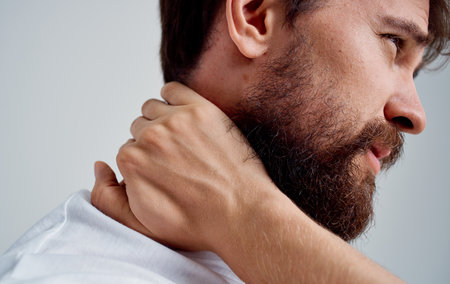 neck pain spine man in t-shirt side viewの写真素材