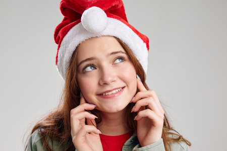happy girls portrait close-up festive cap with round pompomの写真素材